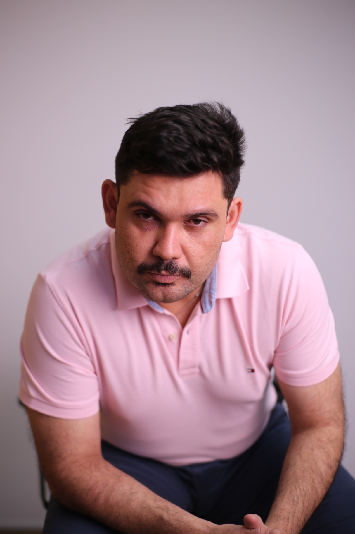 Caio sentado, em atitude de escuta